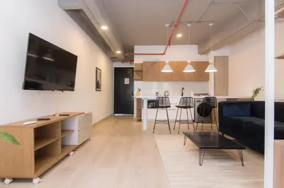 a living room and kitchen with a couch and a table at Lauret Lofts by Wynwood House in Medellín
