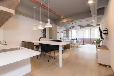 a kitchen and living room with a table and chairs at Lauret Lofts by Wynwood House in Medellín