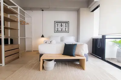 a living room with a white couch and a table at Lauret Lofts by Wynwood House in Medellín