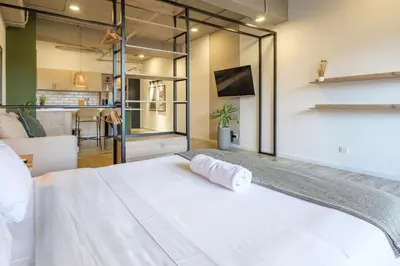a bedroom with a large white bed in a room at Lauret Lofts by Wynwood House in Medellín