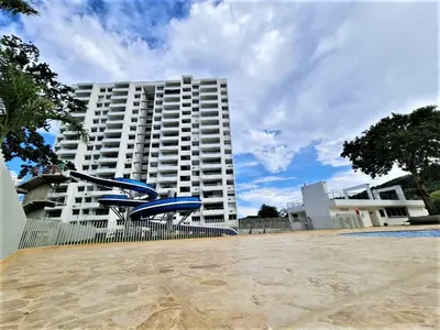 a large white building in front of a building at Apartment cerca centro histórico Sta Fe Antioquia in Santa Fe de Antioquia