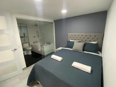 a bedroom with a blue bed with two towels on it at Andy in Bello