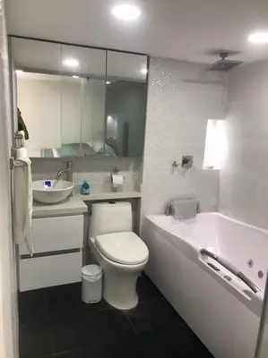 a bathroom with a toilet and a sink and a tub at Andy in Bello