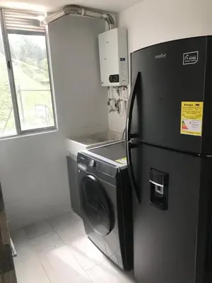 a kitchen with a refrigerator and a washing machine at Andy in Bello
