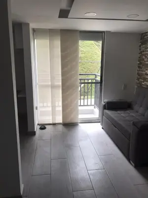 a living room with a couch and a balcony at Andy in Bello