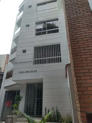 a tall white building with windows on it at Conquistadores Romantic, Medellín in Medellín