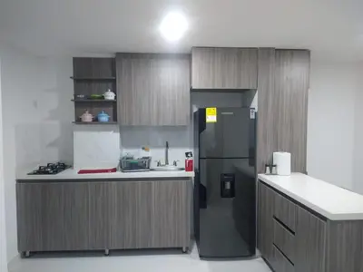 a kitchen with a black refrigerator and a counter at Conquistadores Romantic, Medellín in Medellín