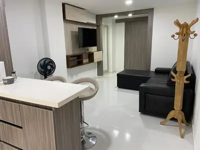 a living room with a bar and a tv at Conquistadores Romantic, Medellín in Medellín