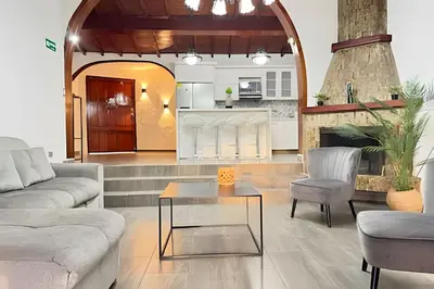 a living room with a couch and a table at Apt Palos Altos Poblado; caminando de restaurantes in Medellín