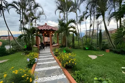 a garden with a gazebo and a pathway at Apt Palos Altos Poblado; caminando de restaurantes in Medellín
