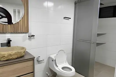a bathroom with a toilet and a sink at Apt Palos Altos Poblado; caminando de restaurantes in Medellín