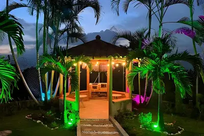 a house with a gazebo with palm trees and lights at Apt Palos Altos Poblado; caminando de restaurantes in Medellín