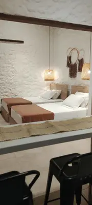 a bedroom with two beds and a chair at La Casa de Nelly - Medellín in Medellín