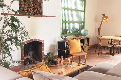 a living room with a couch and a fireplace at La Liebre bed and breakfast in El Retiro