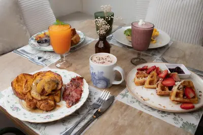 a table topped with plates of breakfast foods and drinks at La Liebre bed and breakfast in El Retiro