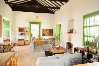 a living room with a couch and a fireplace at La Liebre bed and breakfast in El Retiro