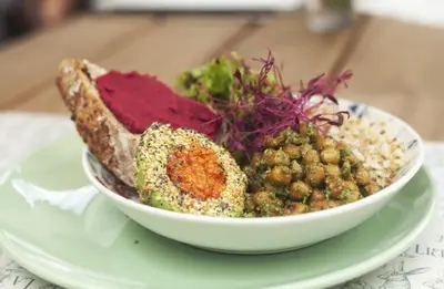a bowl of food on a plate on a table at La Liebre bed and breakfast in El Retiro