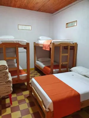 a room with three bunk beds in a room at Hospedaje Campestre El Rancho de Jero in Jardin