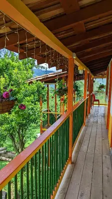 a porch of a house with a wooden deck at Hospedaje Campestre El Rancho de Jero in Jardin
