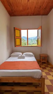 a bed in a room with a window at Hospedaje Campestre El Rancho de Jero in Jardin