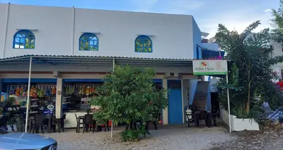 a building with tables and chairs in front of it at Aldea Inmueble in Doradal