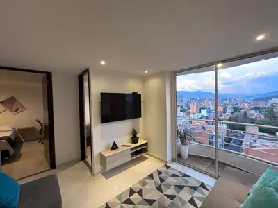 a bedroom with a view of a city at Hermoso y confort Apto en Medellín Cerca al Metro in Medellín