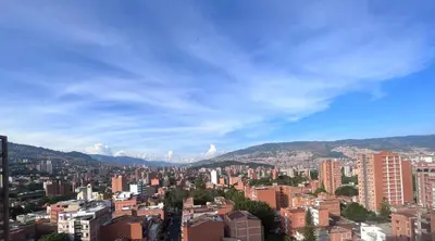 a city with buildings and mountains in the background at Hermoso y confort Apto en Medellín Cerca al Metro in Medellín