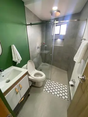 a bathroom with a shower and a toilet and a sink at Balcones de la pradera by Hope in Guatapé