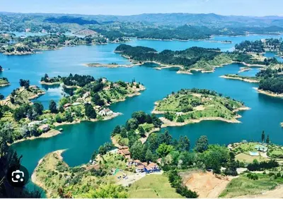 an aerial view of a group of islands in a lake at HOTEL BLUE GUATAPE in Guatapé
