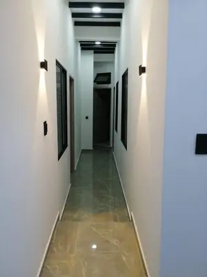 a hallway with white walls and a tile floor at HOTEL BLUE GUATAPE in Guatapé