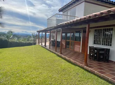 a house with a large lawn in front of it at Finca-hotel Montecarlo Guatape by Hope in Guatapé