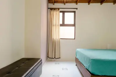 a bedroom with a bed and a window at Rústic-HOUSE Envigado in Envigado