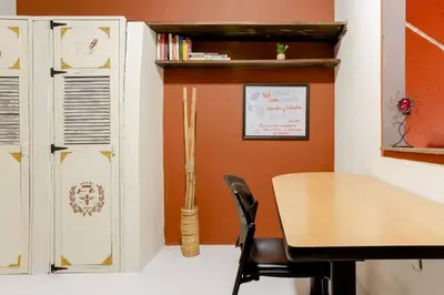 a dining room with a table and a chair at Rústic-HOUSE Envigado in Envigado