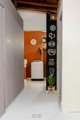 a hallway with a white floor and a black wall at Rústic-HOUSE Envigado in Envigado