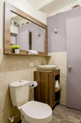 a bathroom with a toilet and a sink at Rústic-HOUSE Envigado in Envigado