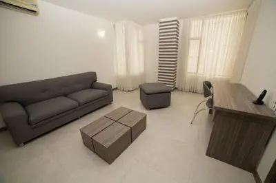 a living room with a couch and a table at Hotel Torre Poblado in Medellín