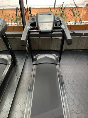 a gym with a screen on top of a treadmill at Hotel Torre Poblado in Medellín