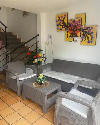 a living room with a couch and chairs and a table at CASA VACACIONAL CON PISCINAS EN SAN JERONIMO - CIUDADELA PREMIUm in Medellín