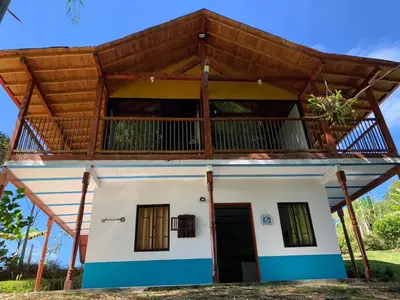 a small house with a large roof at Glamping IKIGAI in Marinilla