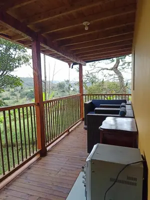 a screened in porch with a couch and a table at Glamping IKIGAI in Marinilla