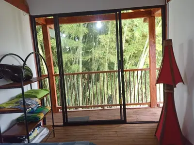 a screened in porch with a sliding glass door at Glamping IKIGAI in Marinilla