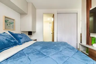 a bedroom with a blue comforter on a bed at Fabulous studio in the heart of Medellín in Medellín