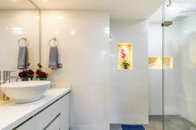 a white bathroom with a sink and a shower at Fabulous studio in the heart of Medellín in Medellín