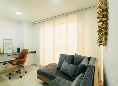 a living room with a couch and a desk at Hermoso y cómodo apartamento en El Poblado!!! in Medellín