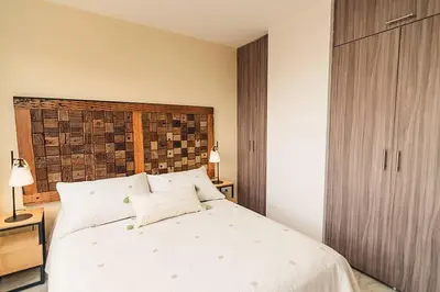 a bedroom with a large white bed with two pillows at Hermoso y cómodo apartamento en El Poblado!!! in Medellín