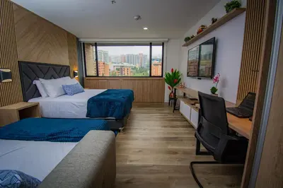 a hotel room with two beds and a window at Unique Suite in El Poblado CoWork/ GYM / Fast WiFi in Medellín