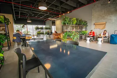 a large table in a room with people sitting at tables at Unique Suite in El Poblado CoWork/ GYM / Fast WiFi in Medellín