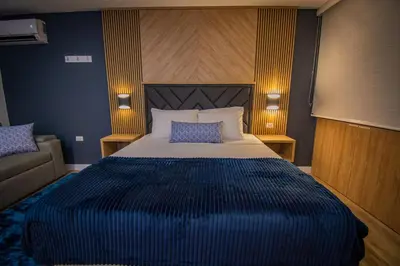 a bedroom with a large bed and a couch at Unique Suite in El Poblado CoWork/ GYM / Fast WiFi in Medellín