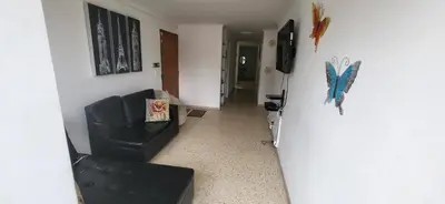 a hallway with a black leather chair in a room at 1023 Los Colores Estadio apartamento - Parqueadero - Zona Wifi - Coworking - Área exclusiva de la ciudad in Medellín