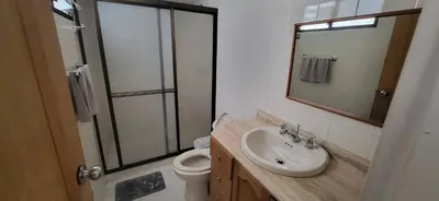 a bathroom with a sink and a toilet and a mirror at 1023 Los Colores Estadio apartamento - Parqueadero - Zona Wifi - Coworking - Área exclusiva de la ciudad in Medellín